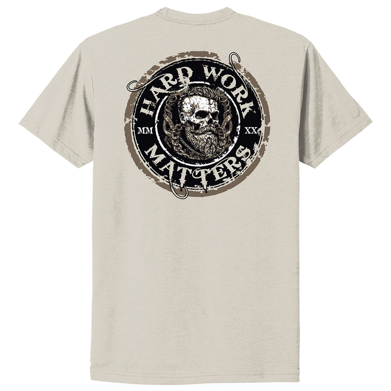 Back of a WW Sand color Graphic Tee, imprinted with "HARD WORK MATTERS" circular text and a rugged skull image in Viking-style design in center of circular image, on full back width in Black, Brown and White inks. (MMXX Roman numerals on the left/right of design printed small.)