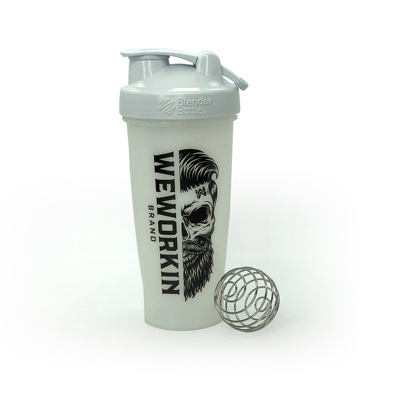 White Classic BlenderBottle® with WeWorkin Brand icon vertically printed in black, large, on side. Wire whisk ball leaning against bottle. On white background.
