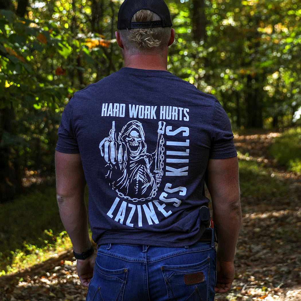 MENS Collection. Man outdoors wearing a WW Hard Work Hurts, Laziness Kills short sleeve tee.