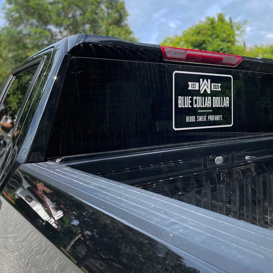 Large WEWORKIN BRAND "BLUE COLLAR DOLLAR" white Decal—Custom die-cut Direct Transfer decal/sticker on the rear window of a black pickup truck.