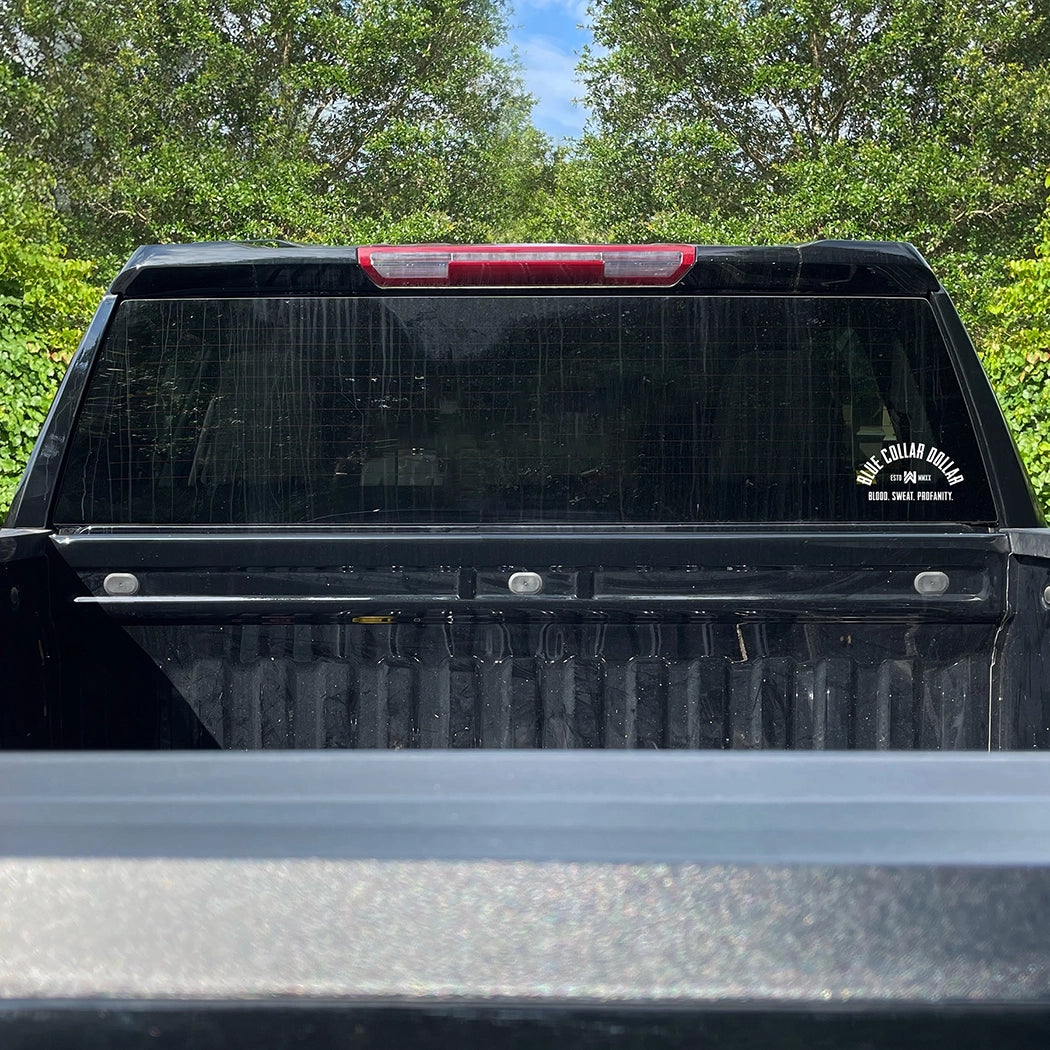 Small WEWORKIN BRAND "BLUE COLLAR DOLLAR" curve-design white Decal—Custom die-cut Direct Transfer decal/sticker on the rear window of a work truck.