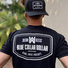 Male outdoors weaing a We Workin black, short sleeve tee with the BLUE COLLAR DOLLAR. BLOOD. SWEAT. PROFANITY. design, printed large on the upper back. Also wearing a Retro Classic 112 all black BCD patch hat.