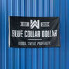 WeWorkin Brand "BLUE COLLAR DOLLAR—Blood. Sweat. Profanity." flag hung on a corrugated metal wall. Each flag measures approx. 5'w x 3'h, black background with grey/white letters. White, double-stitched, thicker left edge for durability, (2) grommets (one at top left and one at bottom left corners).