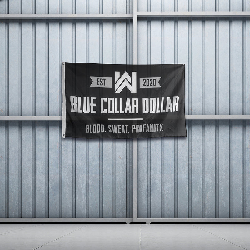 WeWorkin Brand "BLUE COLLAR DOLLAR—Blood. Sweat. Profanity." flag hung on metal sliding doors. Each flag measures approx. 5'w x 3'h, black background with grey/white letters. White, double-stitched, thicker left edge for durability, (2) grommets (one at top left and one at bottom left corners).