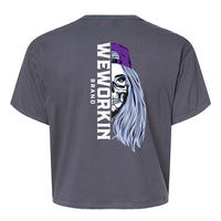 Back of a We Workin Women's short-sleeve cropped tee in dark grey—with a large imprint of our "WEWORKIN BRAND vertical text and Half Skull Woman with Hat" design in Black/White/Grey (hat graphic highlighted in Purple ink.)