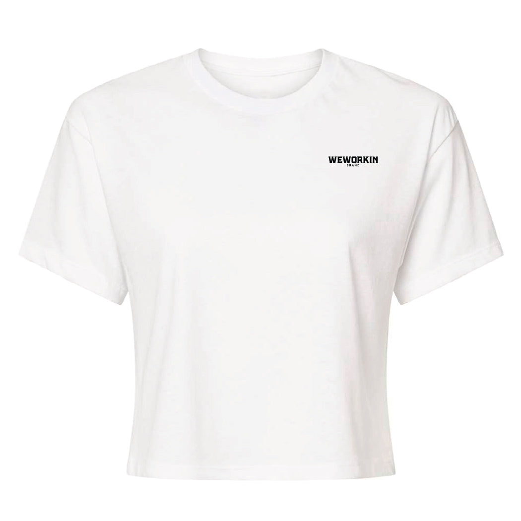 Front of a We Workin Women's short-sleeve cropped tee in white—with a small imprint of our "WEWORKIN BRAND" icon on the upper left chest in Black ink.