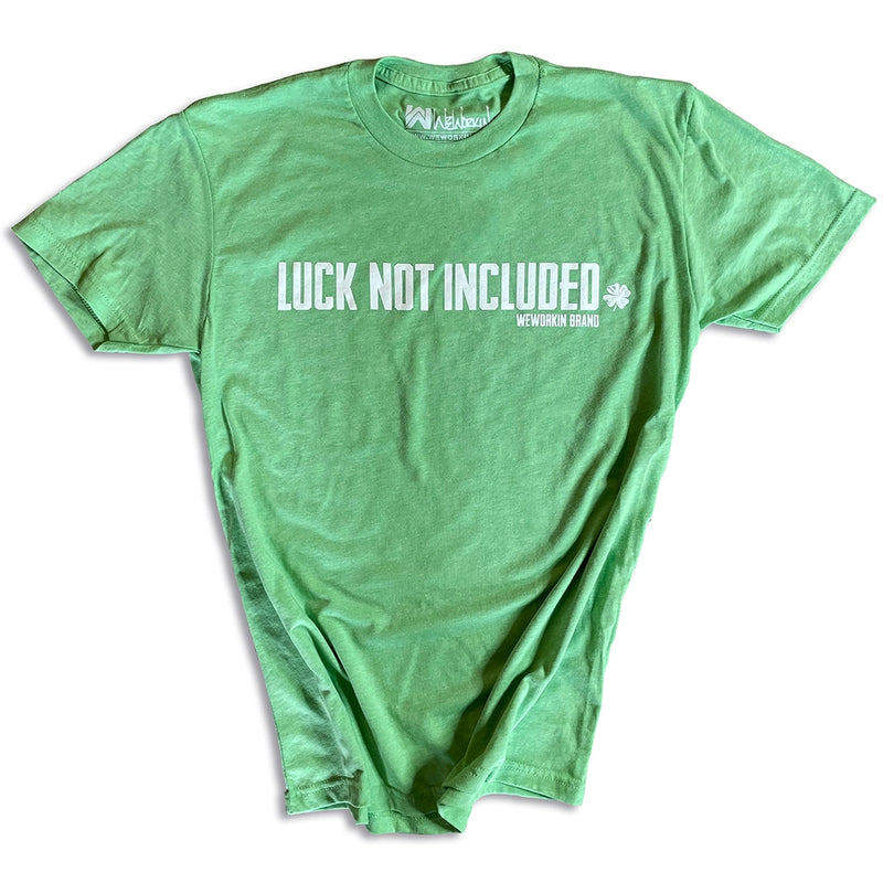 Front of a Green WeWorkin short sleeve tee on white background. Printed large across front of chest, in white ink, LUCK NOT INCLUDED with a 4-leaf clover at the end (WEWORKIN BRAND is underneath main text on right side, small font). 