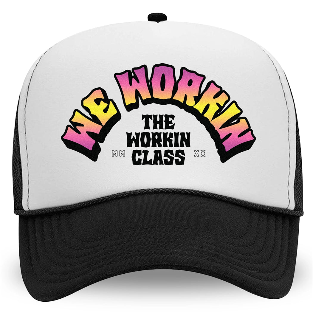 A WeWorkin Foam Trucker Snapback Hat in Black/White/Black colorway, on a white background, pictured from front. The design shows WE WORKIN text in Neon Vibe colors arched over THE WORKIN CLASS stacked text. MM and XX are on the left and right respectively.