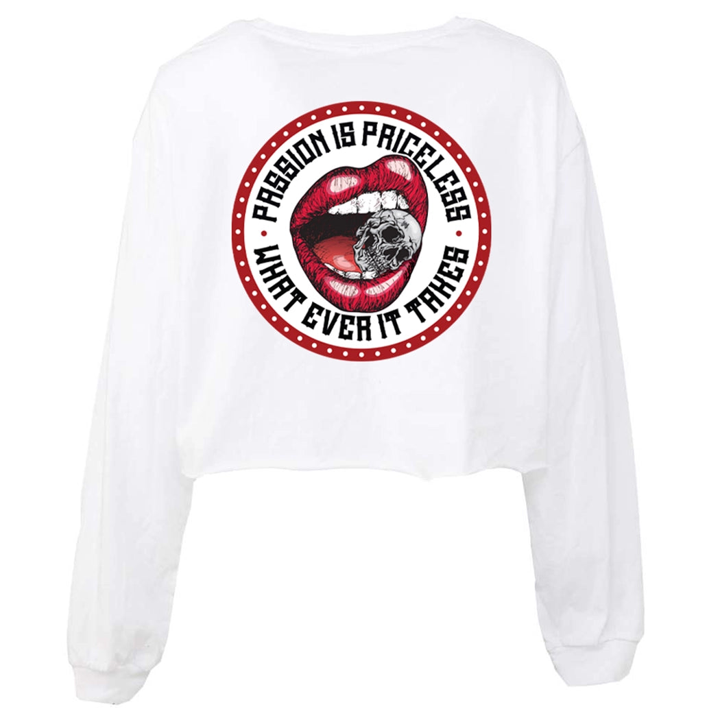 We Workin women’s cropped long sleeve tee in white, on white background. Full color graphic on back includes a circular red-beaded border on white background with red lips-mouth "crunching down" on a skull between teeth in the center, the text "PASSION IS PRICELESS • WHAT EVER IT TAKES" around graphic in black ink.