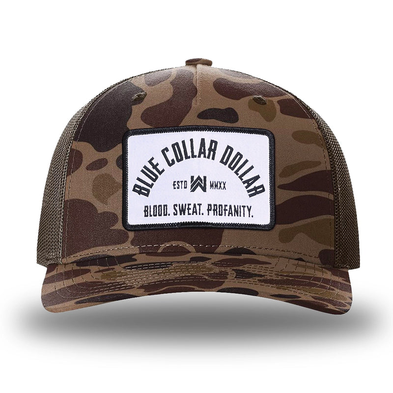 Bark Duck Camo/Brown two-tone WeWorkin hat—Richardson 112PFP snapback, 5-panel trucker, mesh-back style. BLUE COLLAR DOLLAR ARCH (BCD-ARCH) woven patch with black merrowed edge, on a white background with black text, is centered on the front panel.