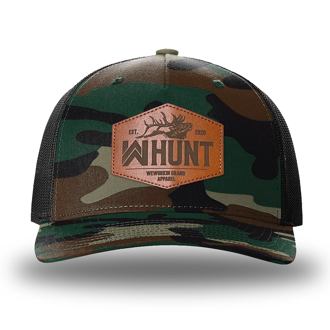 Green Camo/Black two-tone WeWorkin hat—Richardson 112PFP snapback, 5-panel trucker, mesh-back style. WeWorkin "WW HUNT" etched leather patch with stitched border is centered on the front panel.