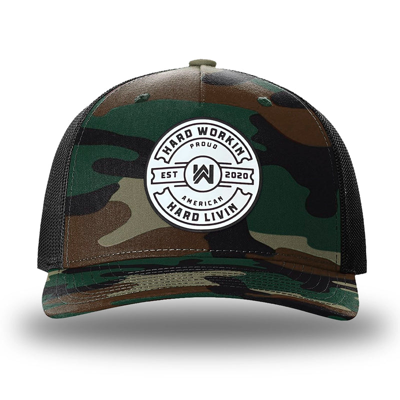 Green Camo/Black two-tone WeWorkin hat—Richardson 112PFP snapback, 5-panel trucker, mesh-back style. WeWorkin "Hard Workin. Hard Livin. Proud American." circular silicone patch is centered on the front panel.