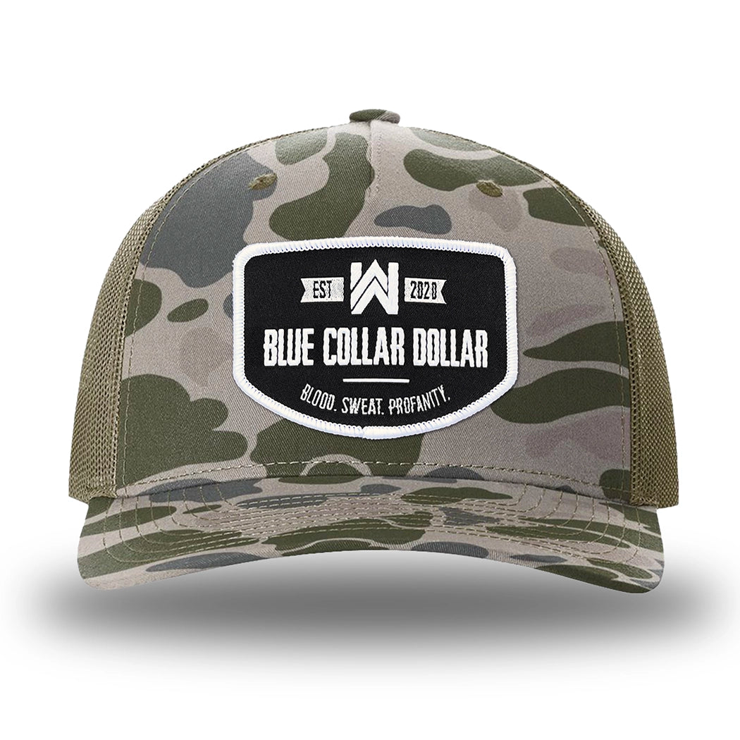 Marsh Duck Camo/Loden two-tone WeWorkin hat—Richardson 112PFP snapback, 5-panel trucker, mesh-back style. WeWorkin "Blue Collar Dollar" curved-bottom woven patch is centered on the front panel.