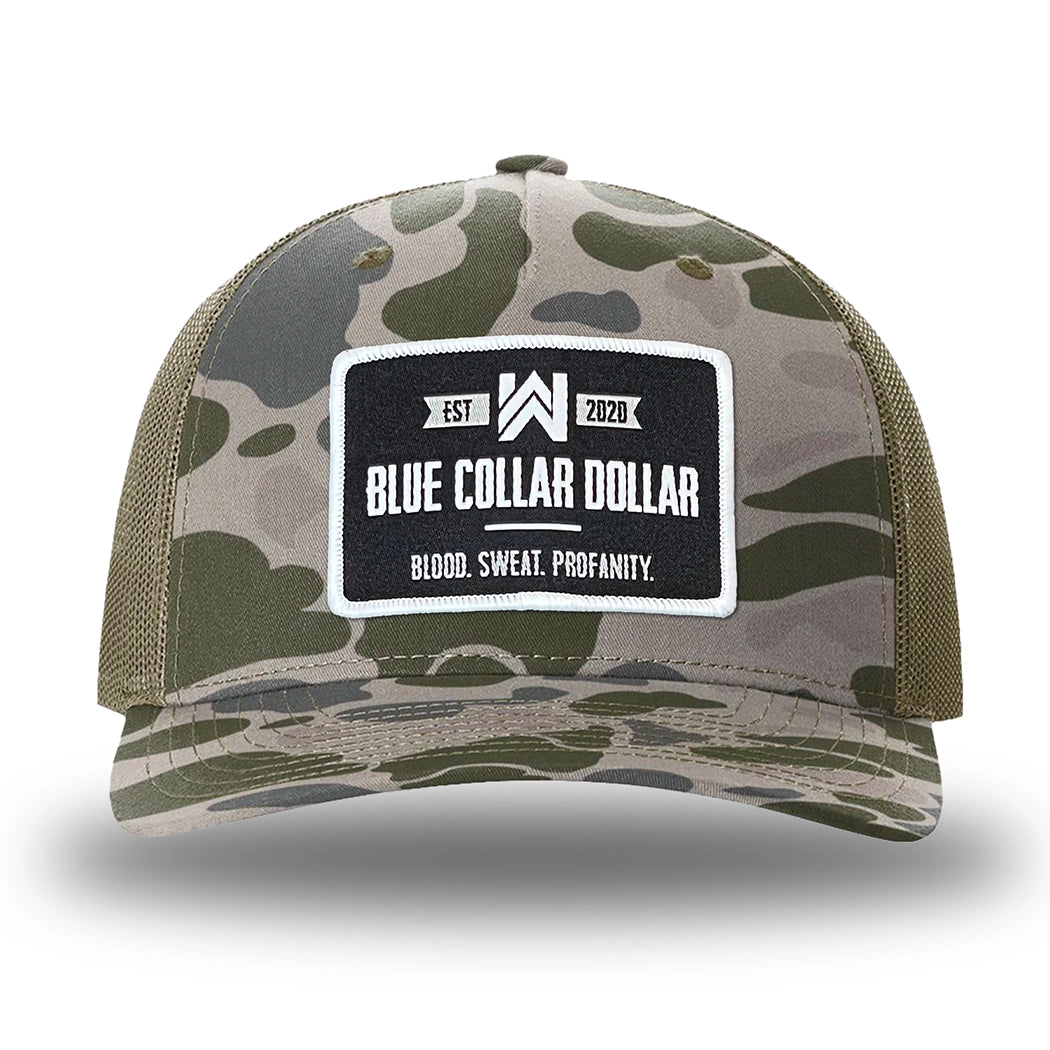 Marsh Duck Camo/Loden two-tone WeWorkin hat—Richardson 112PFP snapback, 5-panel trucker, mesh-back style. WeWorkin "Blue Collar Dollar" rectangular woven patch is centered on the front panel.