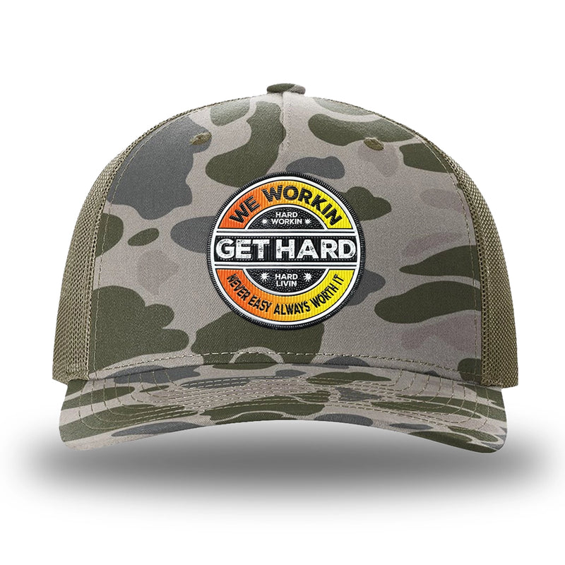 Marsh Duck Camo/Loden two-tone WeWorkin hat—Richardson 112PFP snapback, 5-panel trucker, mesh-back style. WE WORKIN custom GET HARD patch made of thermoplastic, lightweight, durable material is centered on the front panels in orange to yellow fade and black colors.