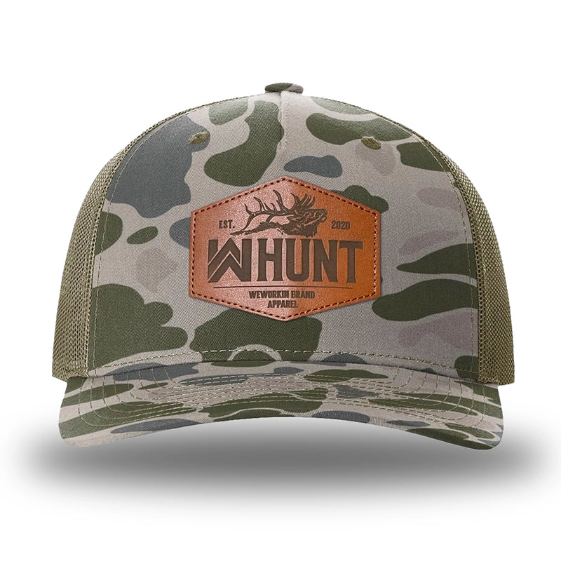 Marsh Duck Camo/Loden two-tone WeWorkin hat—Richardson 112PFP snapback, 5-panel trucker, mesh-back style. WeWorkin "WW HUNT" etched leather patch with stitched border is centered on the front panel.
