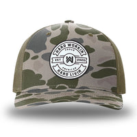 Marsh Duck Camo/Loden two-tone WeWorkin hat—Richardson 112PFP snapback, 5-panel trucker, mesh-back style. Hard Livin. Proud American." circular silicone patch is centered on the front panel.