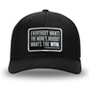 All Black Flex Fit style WeWorkin hat—Woven front with Poly mesh sides and back, Richardson 110 brand (R-Flex trucker). WeWorkin "Everybody Want$ the Money, Nobody Wants the WORK." rectangular woven patch is centered on the front panels.