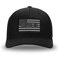 All Black Flex Fit style WeWorkin hat—Woven front with Poly mesh sides and back, Richardson 110 brand (R-Flex trucker). PRO-2A woven patch with black merrowed edge is centered on the front panels.
