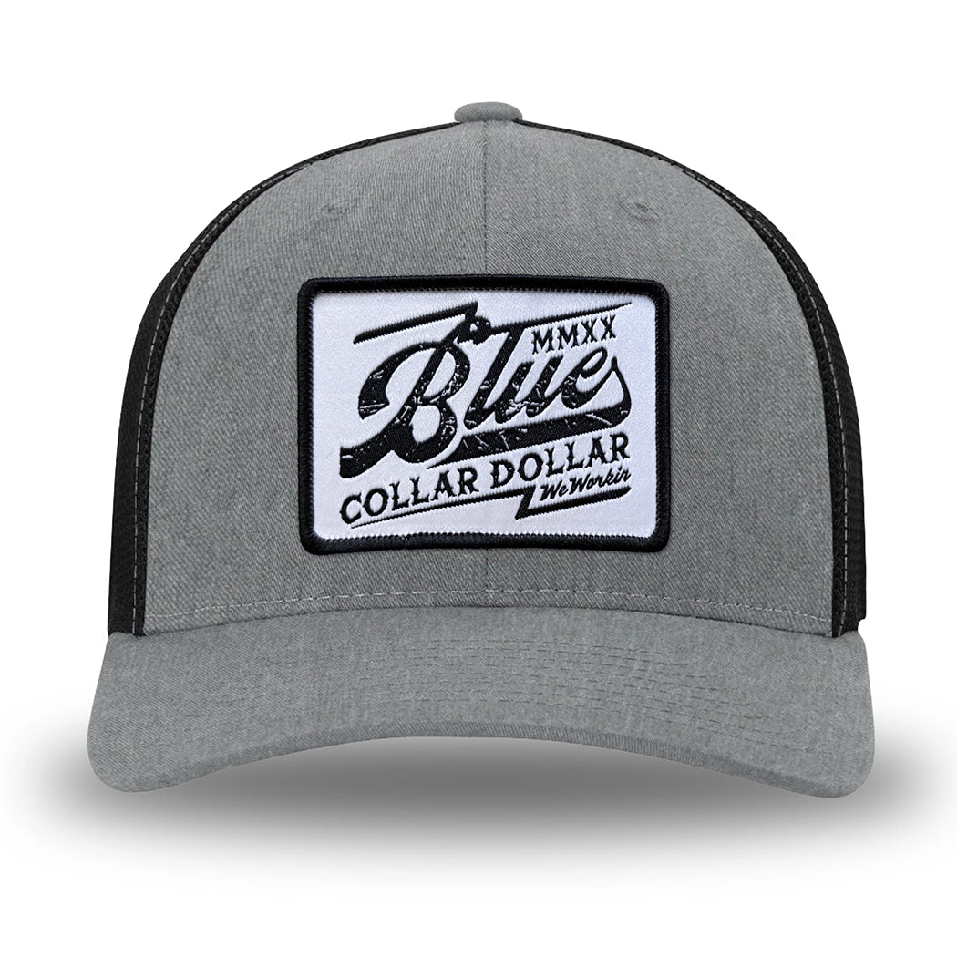 Heather Grey/Black Flex Fit style WeWorkin hat—Woven front with Poly mesh sides and back, Richardson 110 brand (R-Flex trucker). We Workin "Blue Collar Dollar VINTAGE" (BCD-V) woven patch with black merrowed edge, on a white background with black distressed text/graphic, is centered on the front panel.