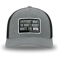 Heather Grey/Black Flex Fit style WeWorkin hat—Woven front with Poly mesh sides and back, Richardson 110 brand (R-Flex trucker). WeWorkin "Everybody Want$ the Money, Nobody Wants the WORK." rectangular woven patch is centered on the front panels.