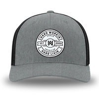 Heather Grey/Black Flex Fit style WeWorkin hat—Woven front with Poly mesh sides and back, Richardson 110 brand (R-Flex trucker). WeWorkin "Hard Workin. Hard Livin. Proud American." circular PVC patch is centered on the front panels.