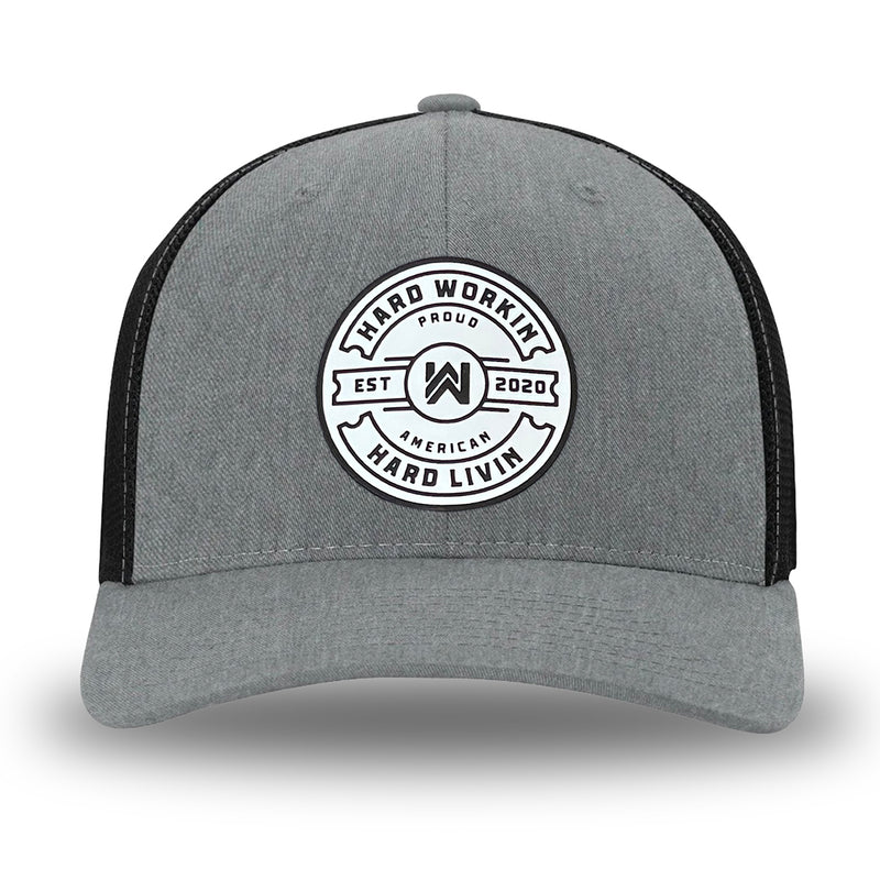 Heather Grey/Black Flex Fit style WeWorkin hat—Woven front with Poly mesh sides and back, Richardson 110 brand (R-Flex trucker). WeWorkin "Hard Workin. Hard Livin. Proud American." circular silicone patch is centered on the front panels.