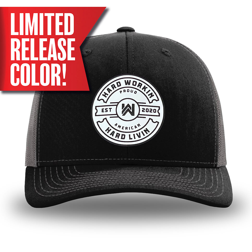 Black and Charcoal Grey two-tone WeWorkin hat—Richardson 112 brand snapback, retro trucker classic hat style. WeWorkin "Hard Workin. Hard Livin. Proud American." circular PVC patch is centered on the front panels.