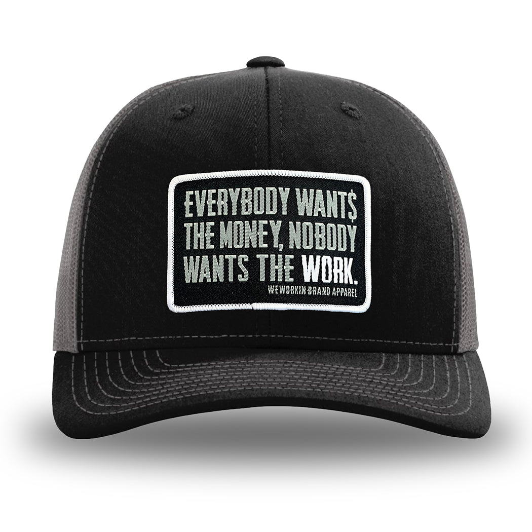 Black and Charcoal Grey two-tone WeWorkin hat—Richardson 112 brand snapback, retro trucker classic hat style. WeWorkin "Everybody Want$ the Money, Nobody Wants the WORK." rectangular woven patch is centered on the front panels.