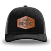 Black and Charcoal Grey two-tone WeWorkin hat—Richardson 112 brand snapback, retro trucker classic hat style. WeWorkin "WW HUNT" etched leather patch with stitched border is centered on the front panels.