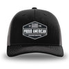 Black and Charcoal Grey two-tone WeWorkin hat—Richardson 112 brand snapback, retro trucker classic hat style. WeWorkin "PROUD AMERICAN" PVC patch is centered on the front panels.