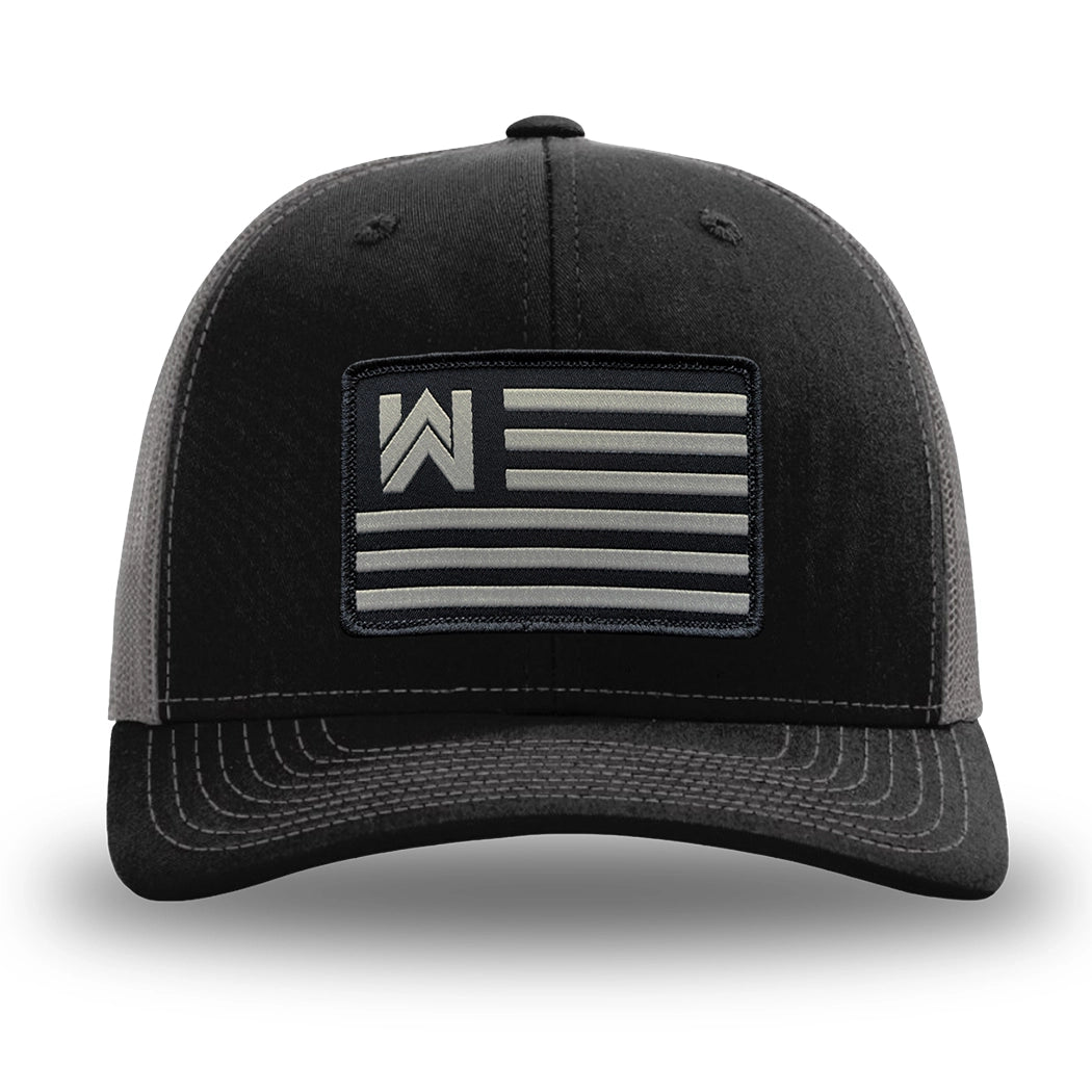 Black and Charcoal Grey two-tone WeWorkin hat—Richardson 112 brand snapback, retro trucker classic hat style. We Workin Flag rectangular patch is centered on the front panels.