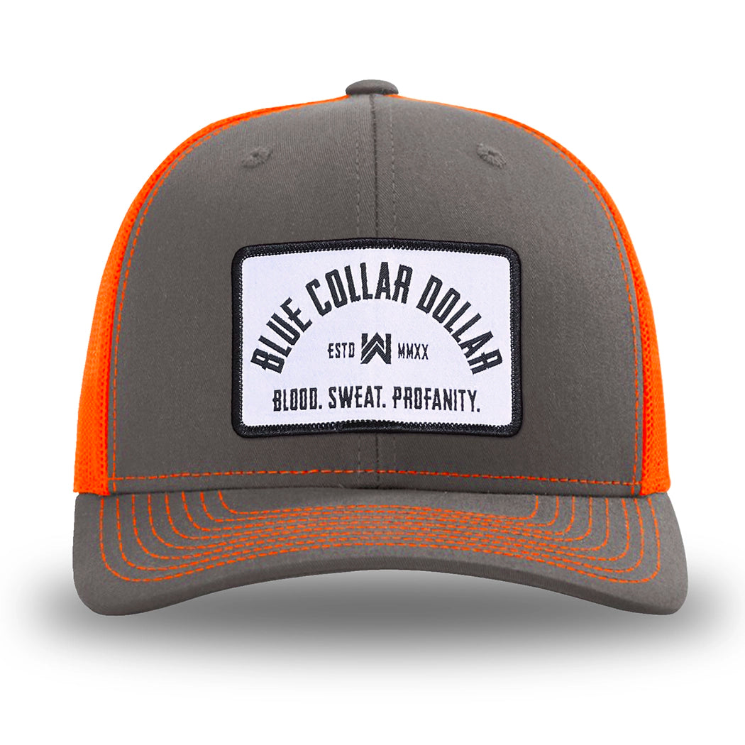 Neon/Safety Orange and Charcoal Grey two-tone WeWorkin hat—Richardson 112 brand snapback, retro trucker classic hat style.  BLUE COLLAR DOLLAR ARCH (BCD-ARCH) woven patch with black merrowed edge, on a white background with black text, is centered on the front panels.