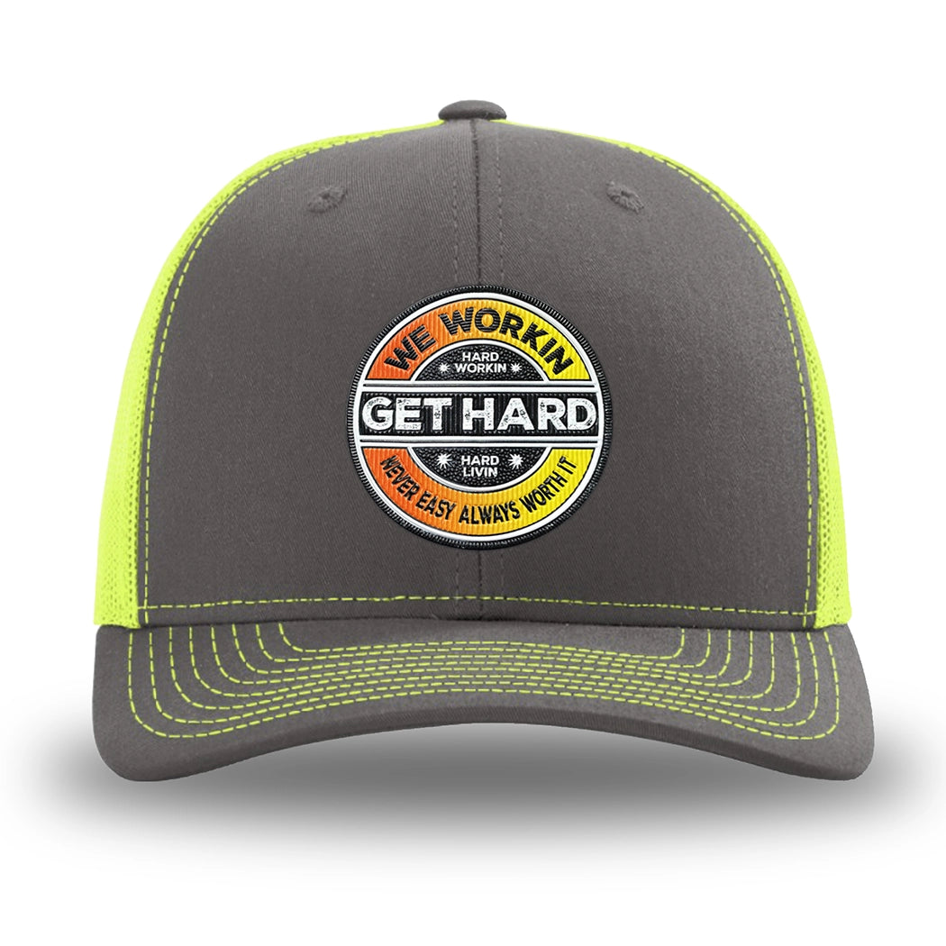 Neon/Safety Yellow and Charcoal Grey two-tone WeWorkin hat—Richardson 112 brand snapback, retro trucker classic hat style. WE WORKIN custom GET HARD patch made of thermoplastic, lightweight, durable material is centered on the front panels in orange to yellow fade and black colors.