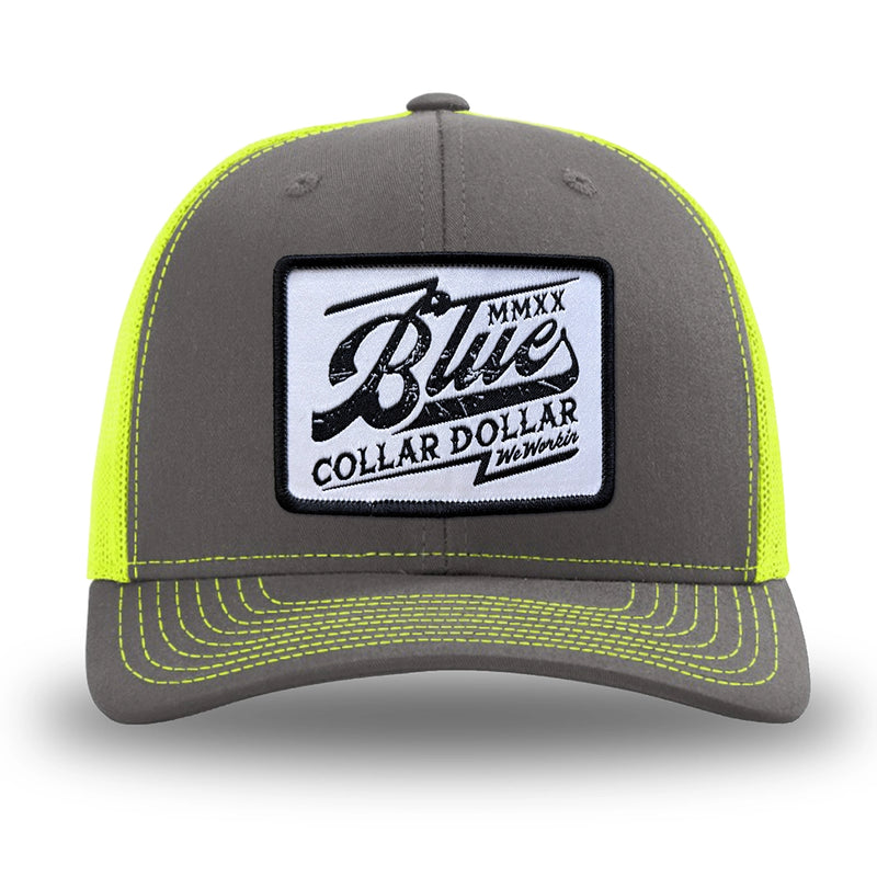 Neon/Safety Yellow and Charcoal Grey two-tone WeWorkin hat—Richardson 112 brand snapback, retro trucker classic hat style. BLUE COLLAR DOLLAR VINTAGE (BCD-V) woven patch with black merrowed edge, on a white background with black, distressed text/design, centered on the front panels.