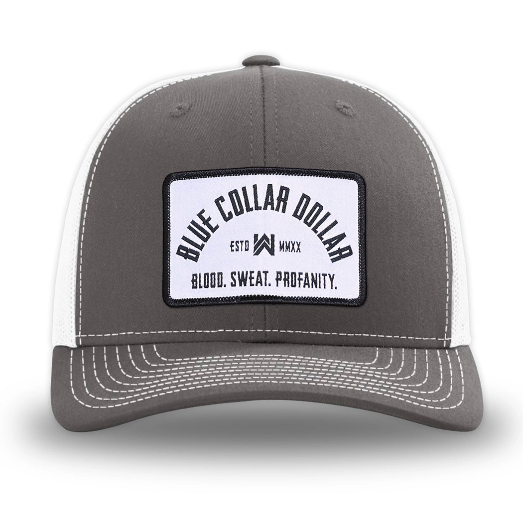 Charcoal/White WeWorkin hat—Richardson 112 brand snapback, retro trucker classic hat style. BLUE COLLAR DOLLAR ARCH (BCD-ARCH) woven patch with black merrowed edge, on a white background with black text, is centered on the front panels.