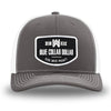 Charcoal/White WeWorkin hat—Richardson 112 brand snapback, retro trucker classic hat style. WeWorkin "Blue Collar Dollar" curve-bottom patch is centered large on the front panels.