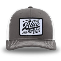 Charcoal/White WeWorkin hat—Richardson 112 brand snapback, retro trucker classic hat style. BLUE COLLAR DOLLAR VINTAGE (BCD-V) woven patch with black merrowed edge, on a white background with black, distressed text/design, centered on the front panels.