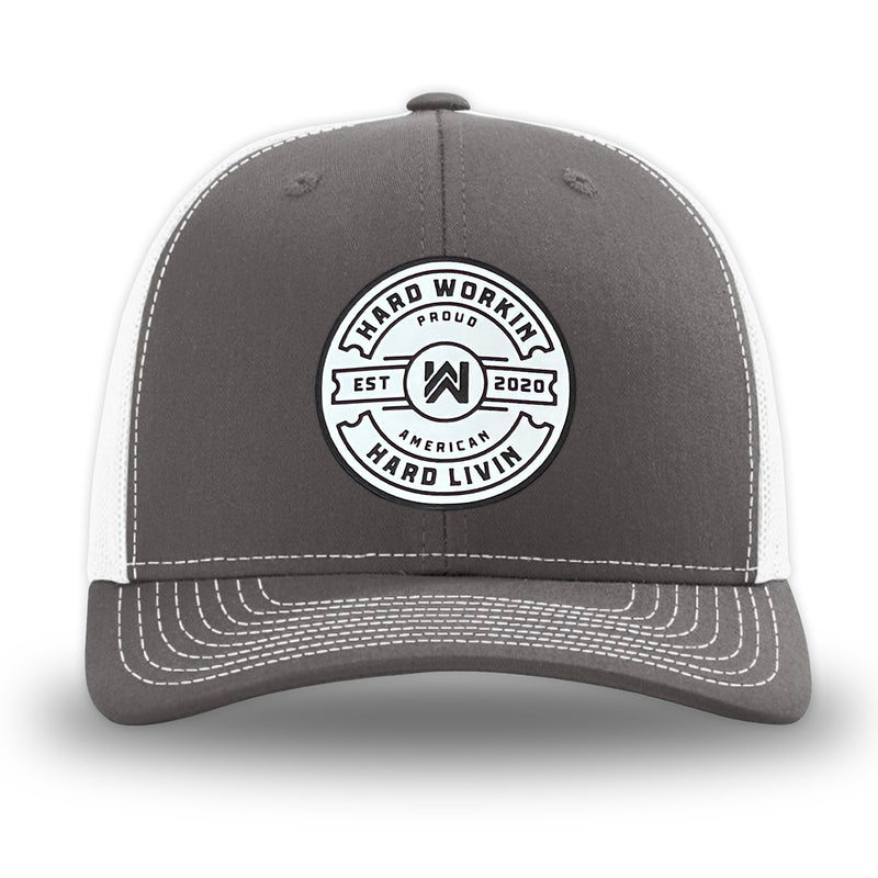 Charcoal/White WeWorkin hat—Richardson 112 brand snapback, retro trucker classic hat style. "HARD WORKIN. HARD LIVIN." Proud American silicone circle patch is centered on the front panels.