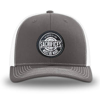 Charcoal/White WeWorkin hat—Richardson 112 brand snapback, retro trucker classic hat style. WeWorkin "SACRIFICES Must Be Made" circular woven patch, with black/white thread colors and black merrowed edge, is centered on the front panels.