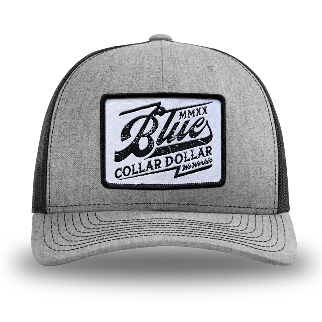 Heather Grey/Black WeWorkin hat—Richardson 112 brand snapback, retro trucker classic hat style. BLUE COLLAR DOLLAR VINTAGE (BCD-V) woven patch with black merrowed edge, on a white background with black, distressed text/design, centered on the front panels.