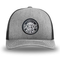 Heather Grey/Black WeWorkin hat—Richardson 112 brand snapback, retro trucker classic hat style. WeWorkin "SACRIFICES Must Be Made" circular woven patch, with black/white thread colors and black merrowed edge, is centered on the front panels.