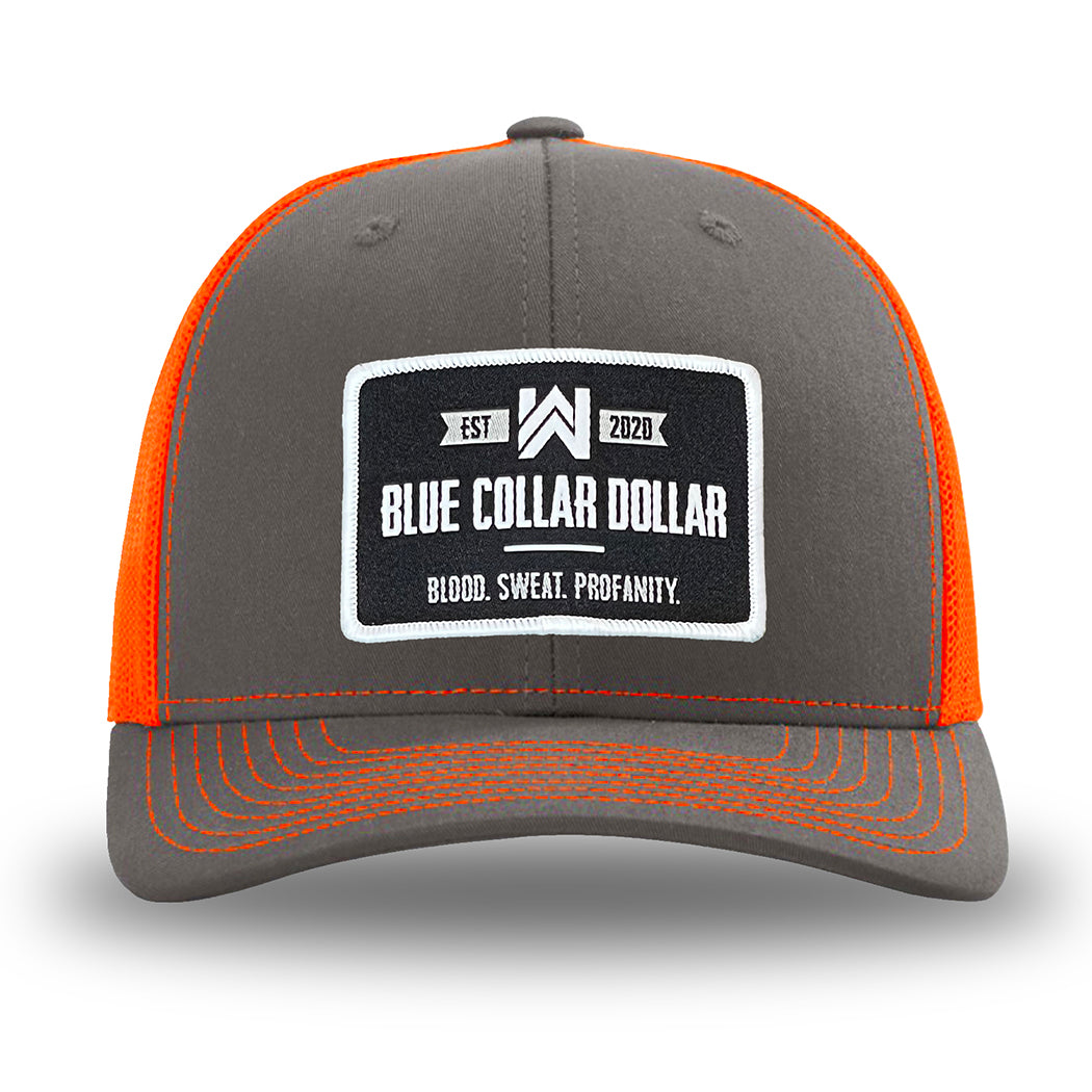 Neon/Safety Orange and Charcoal Grey two-tone WeWorkin hat—Richardson 112 brand snapback, retro trucker classic hat style. WeWorkin "Blue Collar Dollar" rectangular woven patch is centered on the front panels.