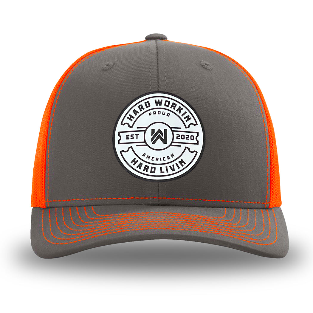 Neon/Safety Orange and Charcoal Grey two-tone WeWorkin hat—Richardson 112 brand snapback, retro trucker classic hat style. WeWorkin "Hard Workin. Hard Livin. Proud American." circular PVC patch is centered on the front panels.