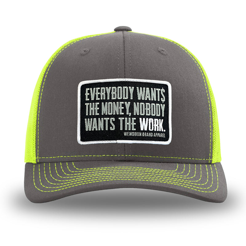 Neon/Safety Yellow and Charcoal Grey two-tone WeWorkin hat—Richardson 112 brand snapback, retro trucker classic hat style. WeWorkin "Everybody Want$ the Money, Nobody Wants the WORK." rectangular woven patch is centered on the front panels.