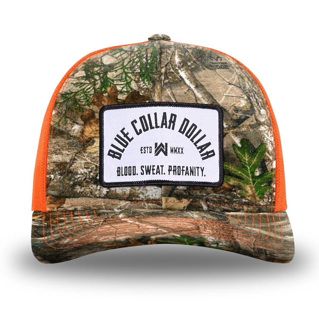 Neon Orange and RealTree Camo two-tone WeWorkin hat—Richardson 112 brand snapback, retro trucker classic hat style. BLUE COLLAR DOLLAR ARCH (BCD-ARCH) woven patch with black merrowed edge, on a white background with black text, is centered on the front panels.