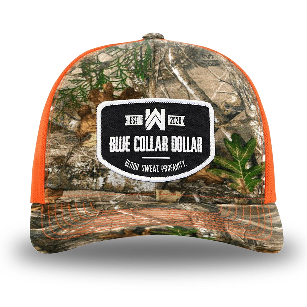 Neon Orange and RealTree Camo two-tone WeWorkin hat—Richardson 112 brand snapback, retro trucker classic hat style. WeWorkin "Blue Collar Dollar" curved-bottom woven patch is centered on the front panels.