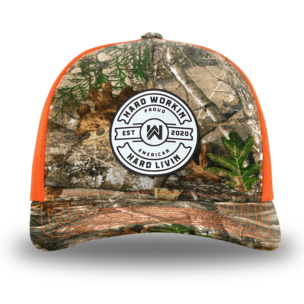 Neon Orange and RealTree Camo two-tone WeWorkin hat—Richardson 112 brand snapback, retro trucker classic hat style. WeWorkin "Hard Workin. Hard Livin. Proud American." circular silicone patch is centered on the front panels.