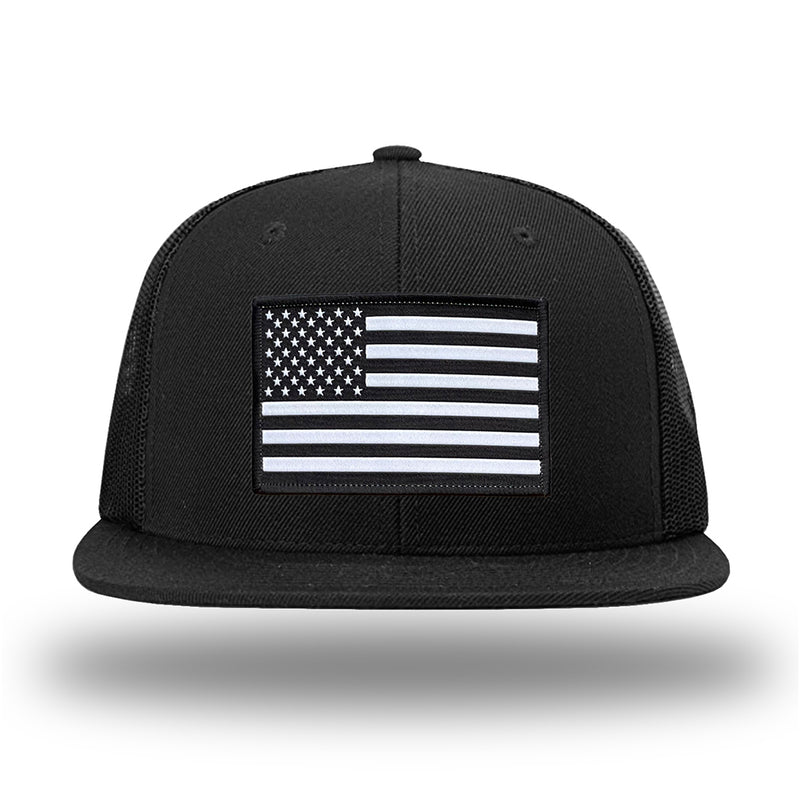 Solid Black WeWorkin hat—Richardson 511 brand snapback, flatbill trucker hat style. AMERICAN FLAG woven patch with black merrowed edge is centered on the front panels.