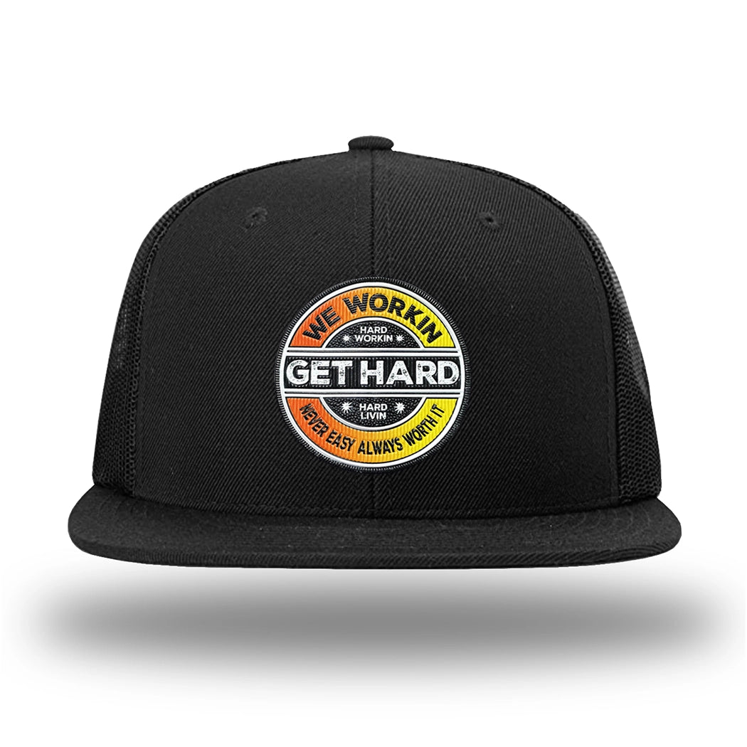 Solid Black WeWorkin hat—Richardson 511 brand snapback, flatbill trucker hat style. WE WORKIN custom GET HARD patch made of thermoplastic, lightweight, durable material is centered on the front panels in orange to yellow fade and black colors.